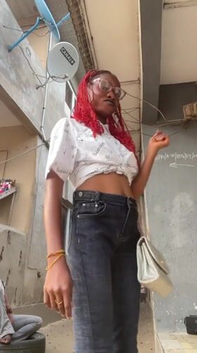 Fashion shoot featuring red-haired woman in Badagry alleyways