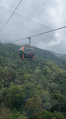 Cable car ride captured over cloudy mountains in Đà Nẵng