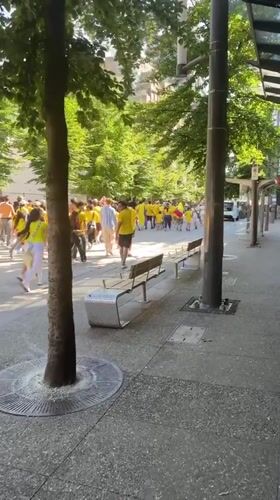 Colombian flag-bearers in yellow march through downtown Vancouver