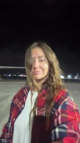 Woman photographed near aircraft at night in Kuta