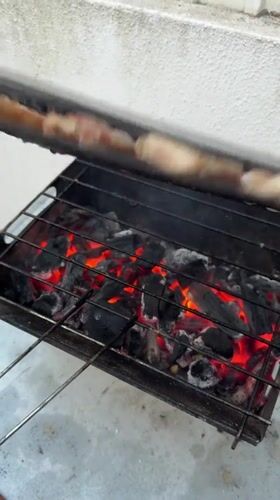 Mixed grill over hot coals in Almada on a summer evening