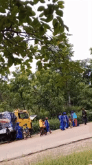 Yellow truck procession with photographs draws crowds in unknown city