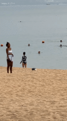 Wedding photoshoot unfolds on busy Nha Trang beach evening