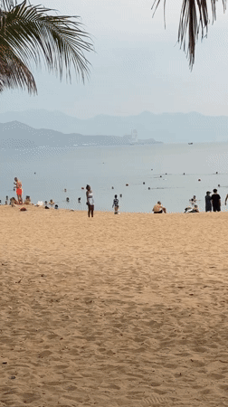 Wedding photoshoot unfolds on busy Nha Trang beach evening
