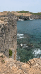 Two SUVs parked near coastal cliffs in Slavyanka, Russia