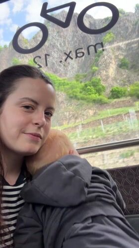 Mother holds sleeping baby in Bad Kreuznach morning scene
