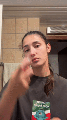 Woman performs evening skincare routine in Montenegro bathroom