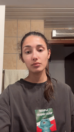 Woman performs evening skincare routine in Montenegro bathroom