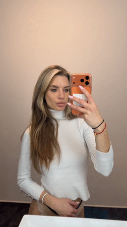 Woman takes selfies on Berlin street near construction