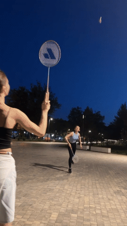 Casual badminton game in a Krasnogorsk park at dusk