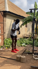Man operates homemade pulley system in Akwanga yard