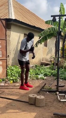 Man operates homemade pulley system in Akwanga yard