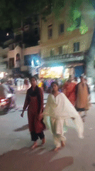 Crowd walks Puttaparthi streets in traditional Indian dress