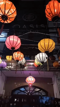 Colorful lanterns illuminate nighttime street scene in Nha Trang