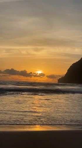 Sunset hour on an Acehnese beach, calm water and warm skies