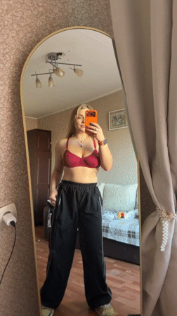 Woman documents mirror selfie session in Russian apartment