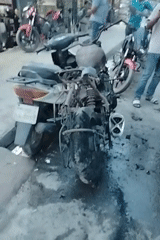 Motorcycle fire aftermath documented on Dhaka street