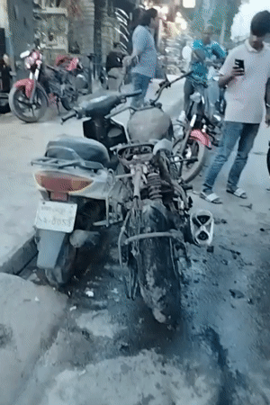 Motorcycle fire aftermath documented on Dhaka street