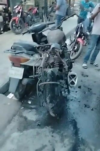 Motorcycle fire aftermath documented on Dhaka street