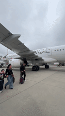 Family Among Passengers Disembarking Aircraft in Arnavutköy, Turkey
