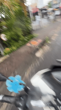Morning scooter ride through wet Kuta Selatan gardens