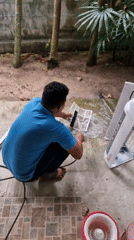 Man performs morning household maintenance in Baan Mae Nam