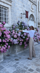 Woman photographed near blooming hydrangeas in Perast, Montenegro