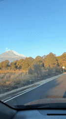 Driver records scenic mountain view on road near Santiago Xalitzintla