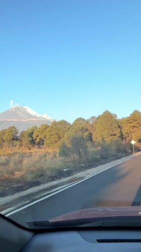 Driver records scenic mountain view on road near Santiago Xalitzintla