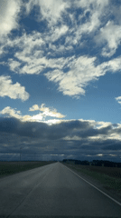 Rural highway documented under cloudy skies in Перевозное, Russia