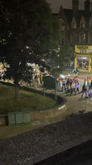 Tutu-wearing group with lights processes through London streets