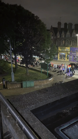 Tutu-wearing group with lights processes through London streets