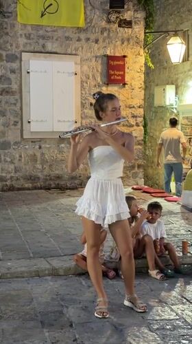 Live flute performance on Budva's historic Trg pjesnika square