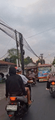 Everyday street life along a busy Desa Dibal roadside