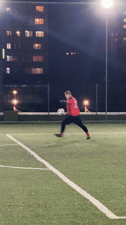 Evening soccer game observed on lit artificial field in Yerevan