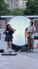 Moscow street musicians perform while zoo visitors feed animals