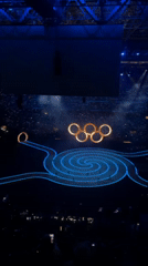 Milan stadium hosts illuminated ceremony with Olympic rings and spiral stage