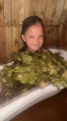 Bathing with green leaves in a rustic wooden room