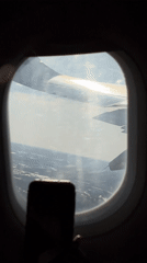 Aircraft wing filmed from passenger window over Orlando