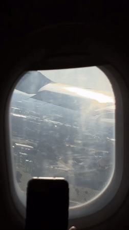 Aircraft wing filmed from passenger window over Orlando