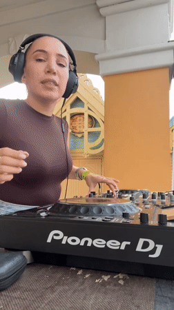 Female DJ performs outdoor set in decorative Moscow venue
