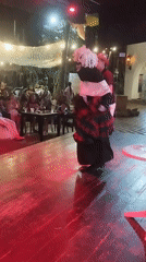 Costumed performers entertain late-night karaoke crowd in Porlamar