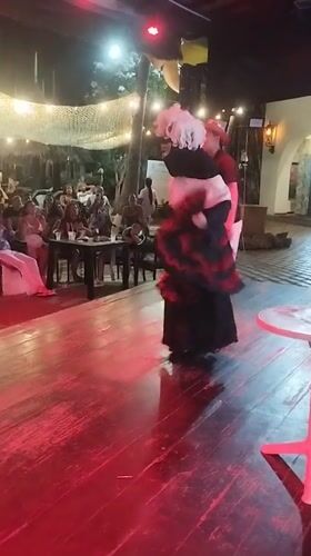 Costumed performers entertain late-night karaoke crowd in Porlamar