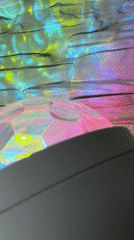 Woman films with colorful disco lighting effects indoors