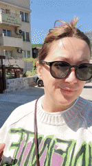 Woman walks multiple dogs through Budva cafes and streets