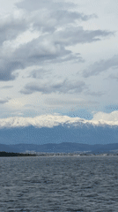 Snow-capped mountains viewed across choppy waters in Fethiye, Turkey