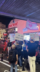 Nighttime protest with Hebrew signs unfolds in Tel Aviv