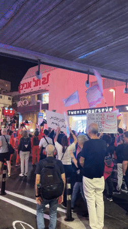 Nighttime protest with Hebrew signs unfolds in Tel Aviv