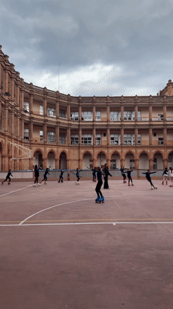 Barcelona afternoon scenes include children ice skating, Columbus Monument