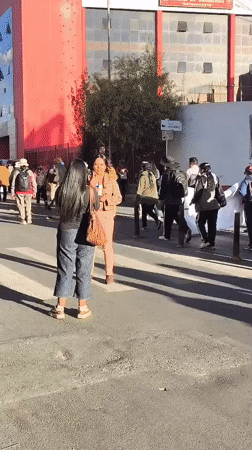 Group carries white banner in street demonstration in La Paz